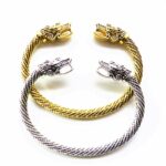 Bracelet vintage à manchette ouverte tête de dragon, doré et argenté. Bonne qualité et très tendance.