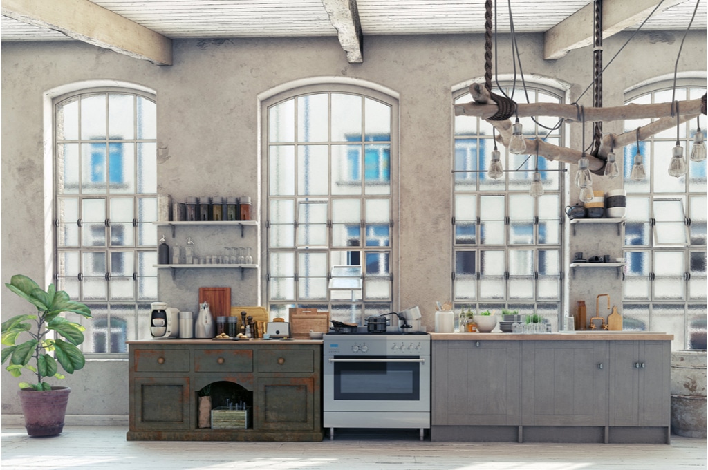 cuisine moderne et vintage dans les tons gris clair. de larges baies vitrées apportent beaucoup de lumière dans la pièce.