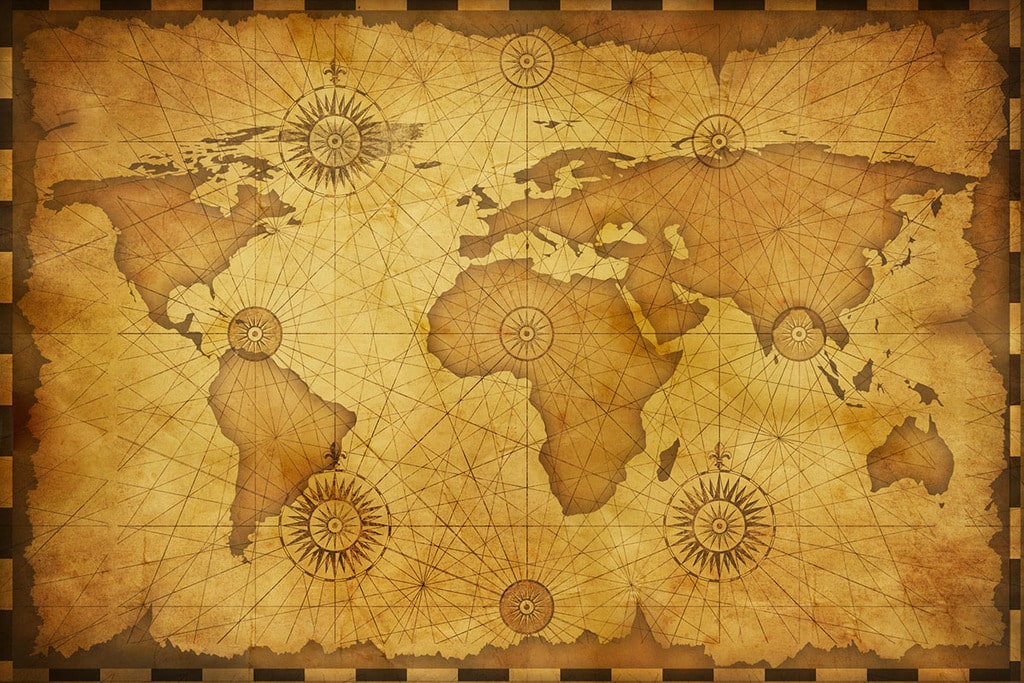 carte du monde nautique vintage de couleur vieux jaune avec des tracés et points cardinaux dessinés dessus